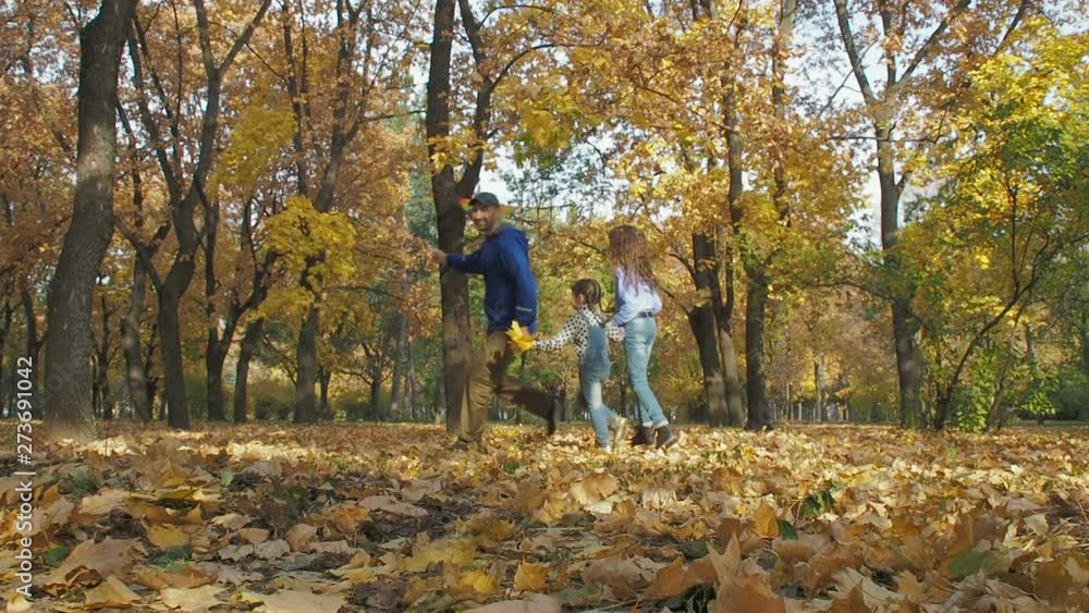 Children playin kite with father. Cheerful father with daughters play with a kite in the autumn park. Children playin kite with father. Cheerful father with daughters play with a kite in the autumn park.