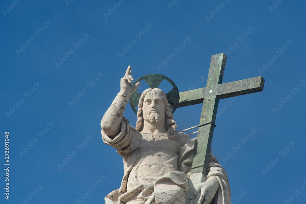 Vatican City - February 27, 2019: Statue of Jesus on the top of Saint Peter Basilica facade.