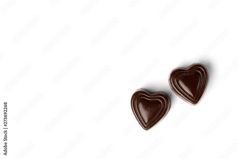Two chocolate sweets in heart shape isolated on white background. Top view. Two chocolate sweets in heart shape isolated on white background. Top view.