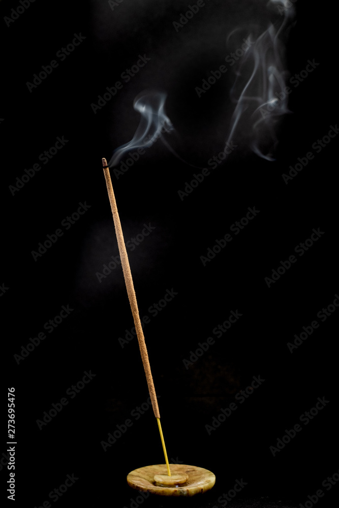 incense joss stick burning on black background with smoke incense joss stick burning on black background with smoke