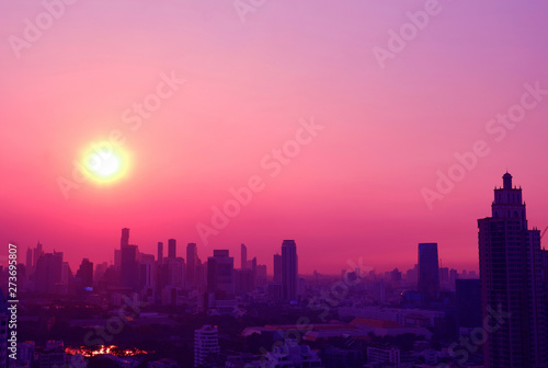 Fototapeta Naklejka Na Ścianę i Meble -  Pop art style dreamy sunset over the skyscrapers in pink and purple color