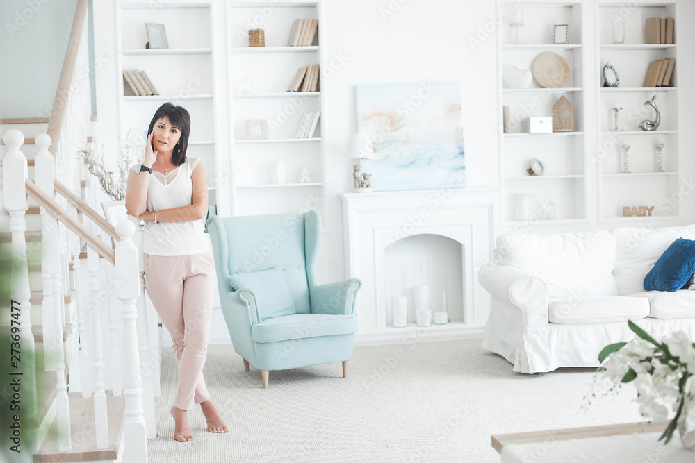 Attractive mid adult woman indoors. Adult female portrait. Beautiful woman at home. Attractive mid adult woman indoors. Adult female portrait. Beautiful woman at home.