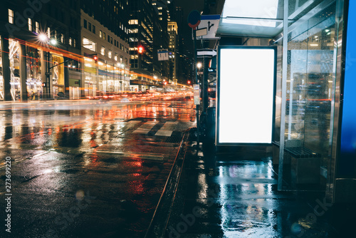 Photography Bus station billboard in rainy night with blank copy space screen for advertisin