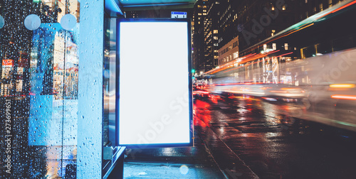 Billede på lærred Bus station billboard in rainy night with blank copy space screen for advertisin