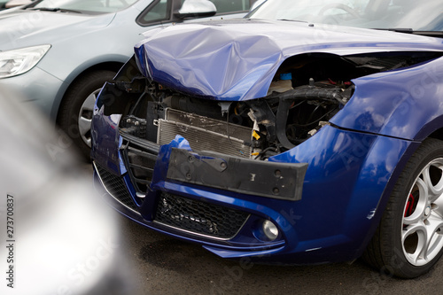 Detail Of Car Damaged In Motor Vehicle Accident Parked In Garage Repair Shop © Monkey Business
