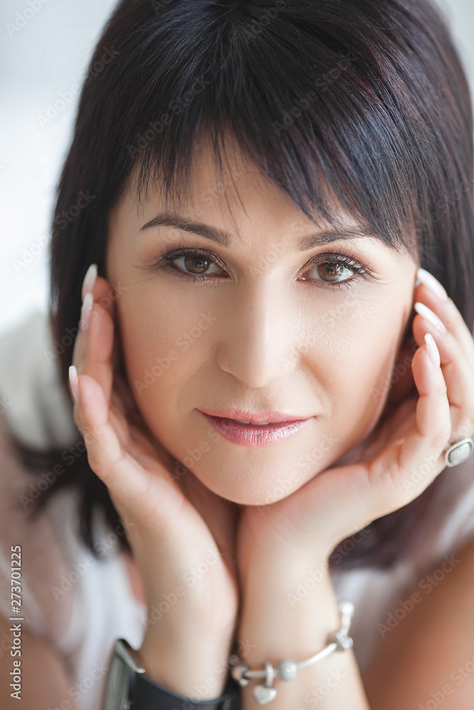 Closeup portrait of beautiful mature woman. Mid adult lady indoors. Smiling woman. Attractive female. Closeup portrait of beautiful mature woman. Mid adult lady indoors. Smiling woman. Attractive female.