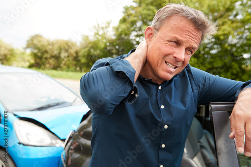 Cuadro en lienzo Mature Male Motorist With Whiplash Injury In Car Crash Getting Out Of Vehicle