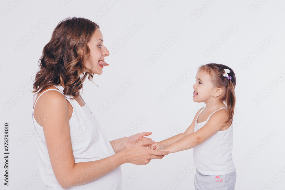 mother and daughter show each other language. Health and hygiene in women on a white background mother and daughter show each other language. Health and hygiene in women on a white background
