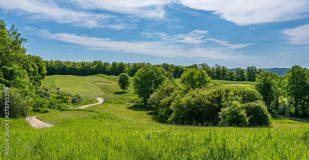 rolling hills of golf course on a bright sunny day