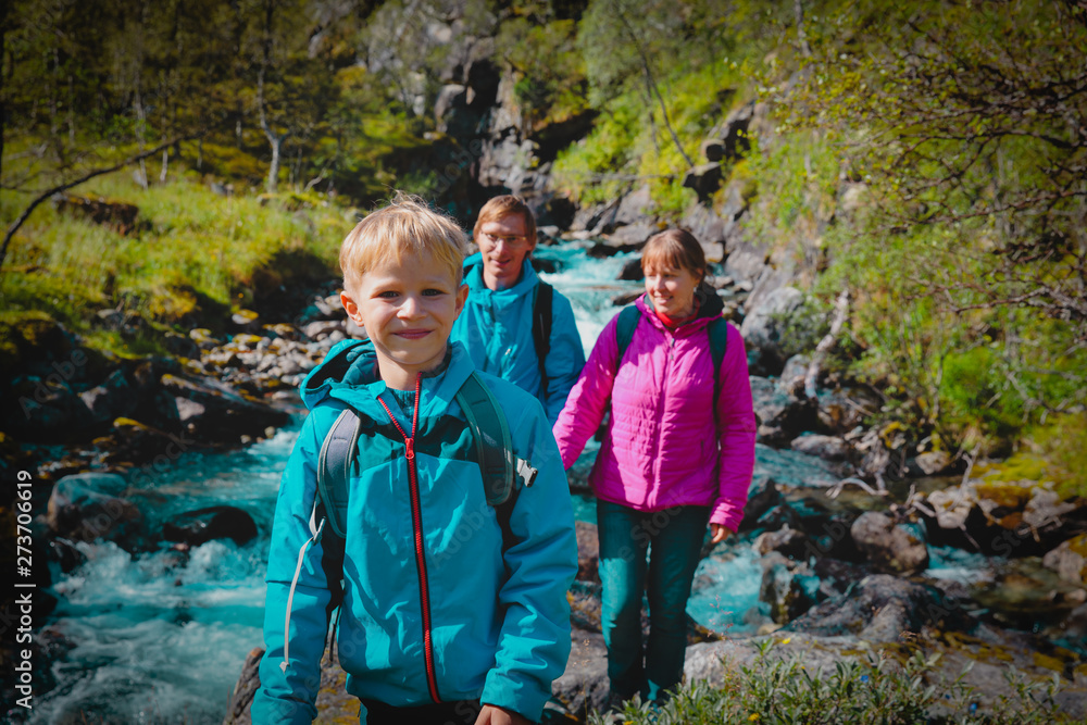 family with child travel in nature, tourists hiking in Norway