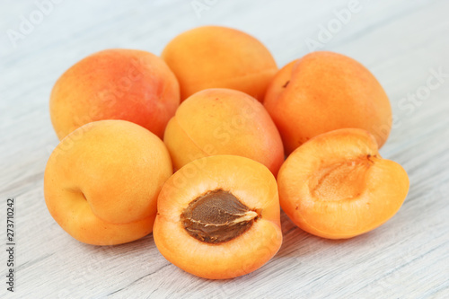 Fresh ripe orange apricot fruits on table