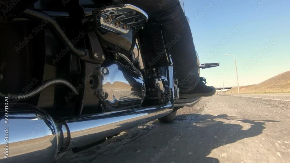 The motorcyclist slowly turns on an empty highway to continue his free ride The motorcyclist slowly turns on an empty highway to continue his free ride