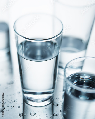 Background image of selective focus water glasses with pure clean water