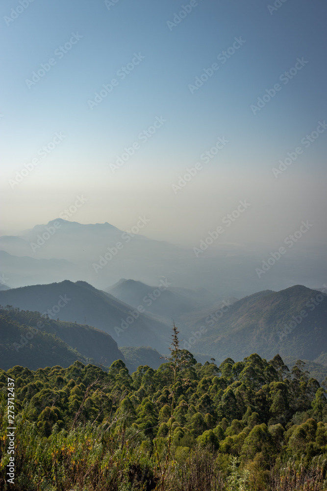 Mountain range in mist with amazing blue sky