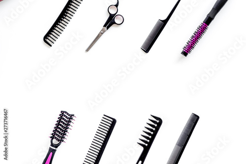 Hairdresser equipment for cutting hair and styling with combs, sciccors, brushes on white background top view copyspace