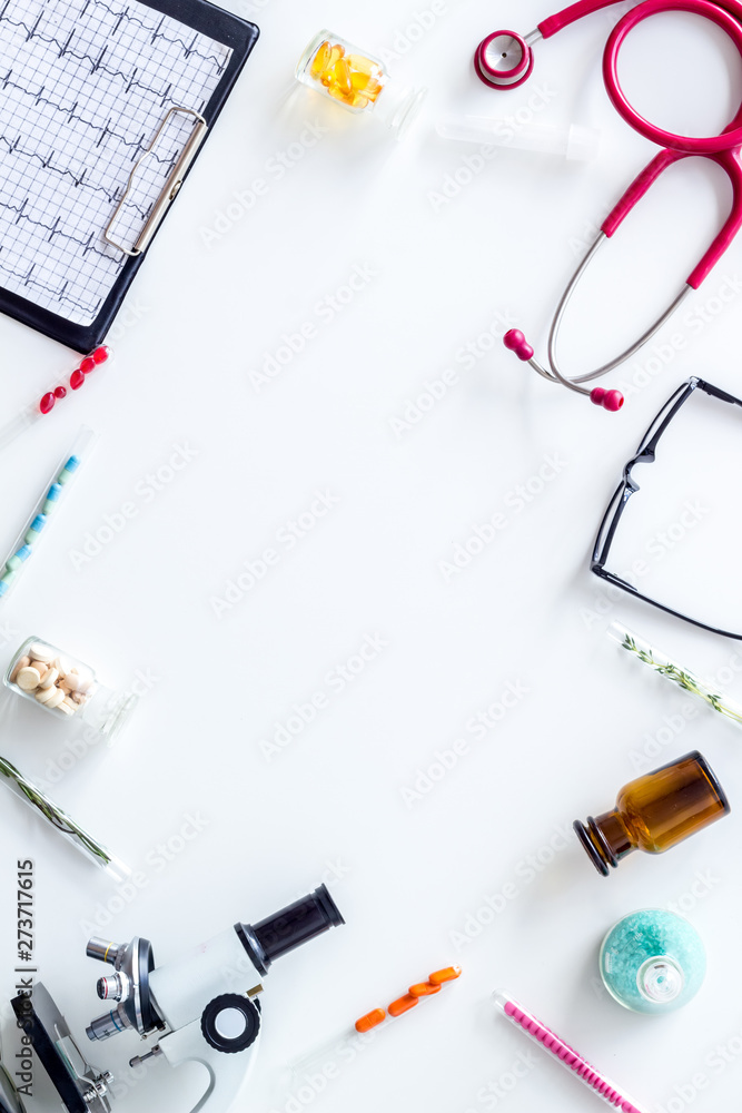 Do medical research with microscope, stethoscope, pad, pills and test tube on white background top view mock up Do medical research with microscope, stethoscope, pad, pills and test tube on white background top view mock up