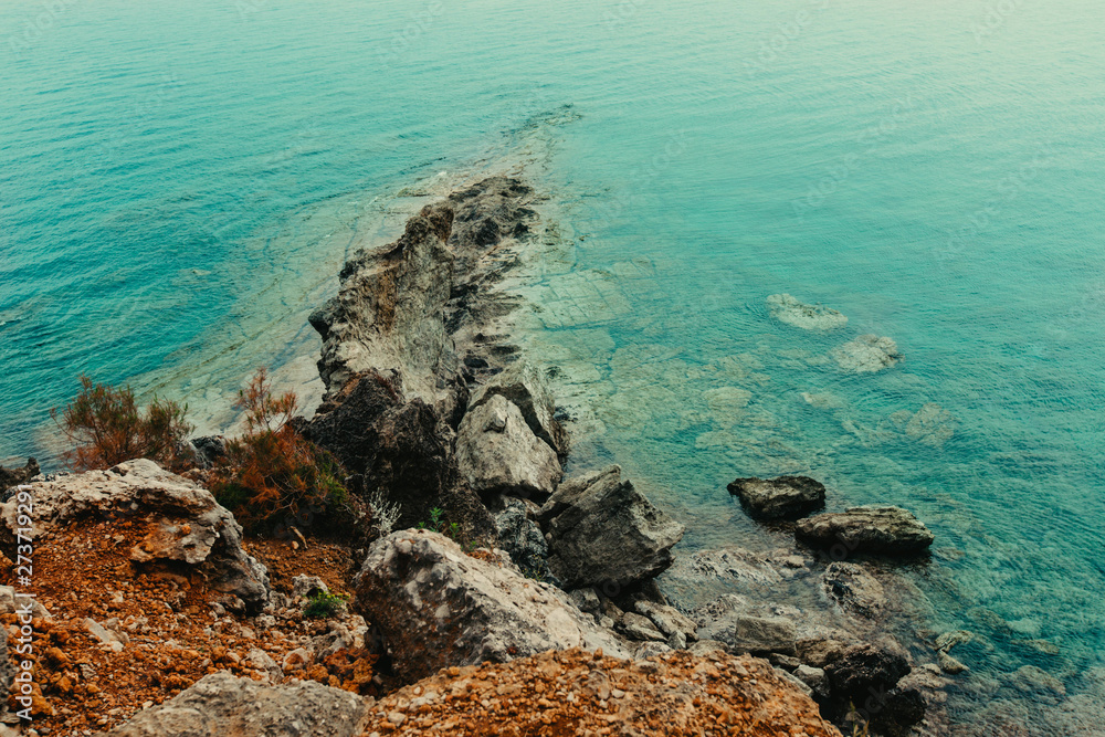 Panoramic view of tropical landscape. Bay in the Mediterranean Sea with blue water and a stones. On the rocks grow pines, beautiful view from above. Concept of water travel, cruises, vacations and Panoramic view of tropical landscape. Bay in the Mediterranean Sea with blue water and a stones. On the rocks grow pines, beautiful view from above. Concept of water travel, cruises, vacations and