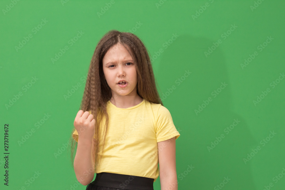 child is at risk of a fist, a little girl angry child is at risk of a fist, a little girl angry