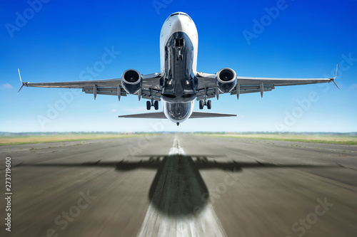 take off of an modern airliner against a blue sky photo
