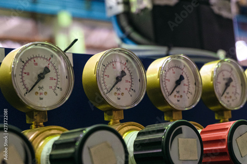 Pressure gauges with adjustment valves in industrial plant shop. Oxygen supply. Limited depth of field.