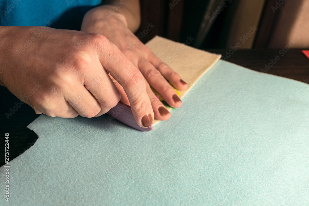 Sewing master makes handicraft of fabric. Felt products. Cutting with a mark of soap. Sewing master makes handicraft of fabric. Felt products. Cutting with a mark of soap.