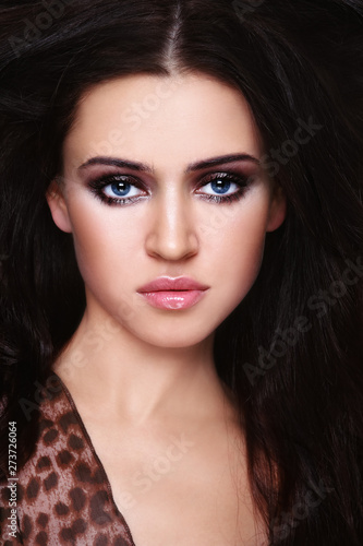 Young beautiful sexy woman with dark long hair and fancy smoky eye makeup
