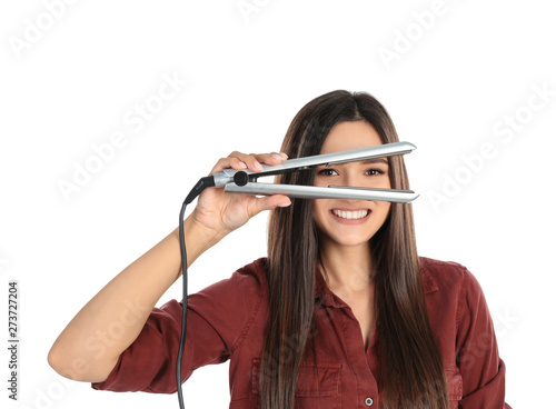 Young woman with modern hair iron on white background