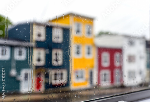 Rain drops on windows with jellybean houses in St. John's, Newfoundland photo