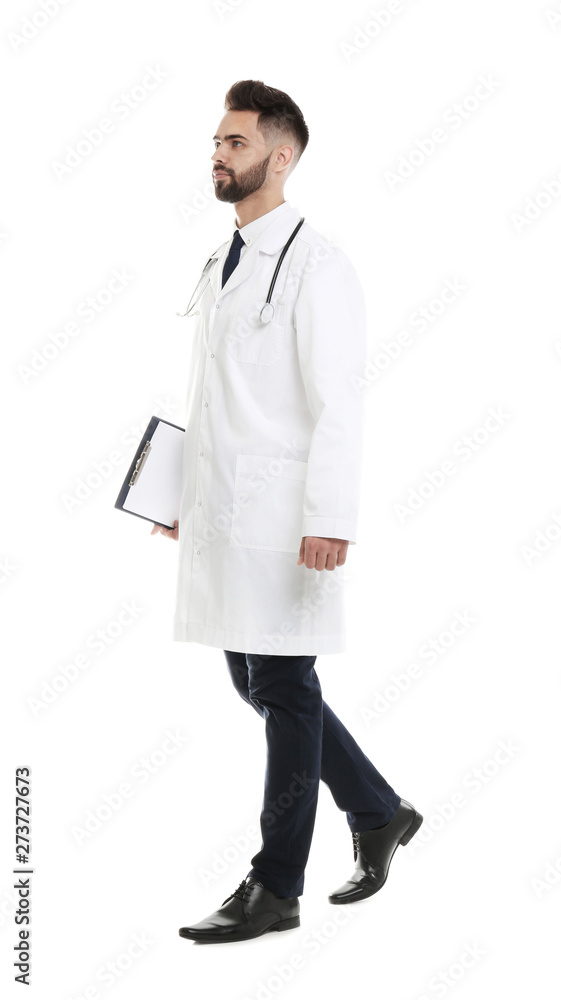 Young male doctor in uniform with clipboard isolated on white Young male doctor in uniform with clipboard isolated on white