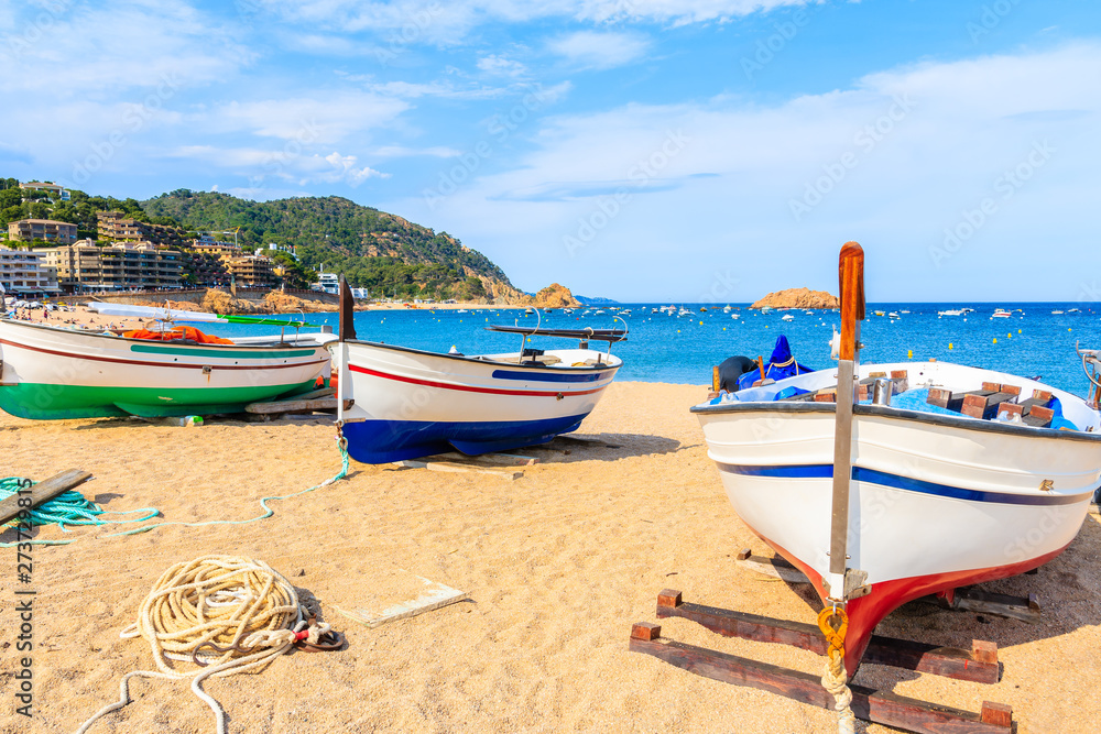 Fishing boats on golden sand beach in Tossa de Mar town, Costa Brava, Spain Fishing boats on golden sand beach in Tossa de Mar town, Costa Brava, Spain