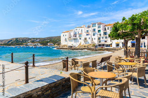 Restaurant tables along sea in Cadaques village, Costa Brava, Spain