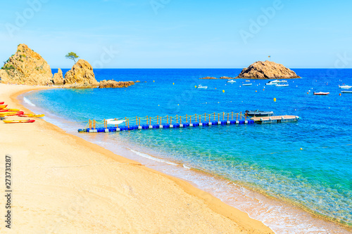 Fototapeta Naklejka Na Ścianę i Meble -  Azure blue water on idyllic beach in Tossa de Mar town, Costa Brava, Spain