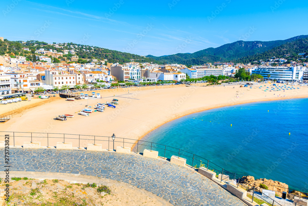 View of sandy beach and bay in Tossa de Mar town from castle, Costa Brava, Spain