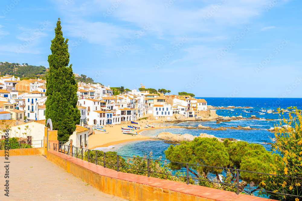 View of Calella de Palafrugell, scenic fishing village with white houses and sandy beach with clear blue water, Costa Brava, Catalonia, Spain
