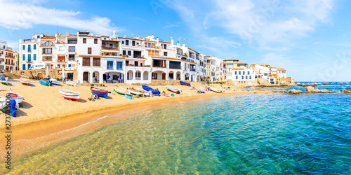 CALELLA DE PALAFRUGELL, SPAIN - JUN 6, 2019: Panorama of amazing beach in scenic fishing village with white houses and sandy beach with clear blue water, Costa Brava, Catalonia, Spain. photo