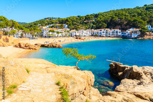 Stunning sandy beach and azure blue water of sea bay in Tamariu seaside town, Costa Brava, Spain