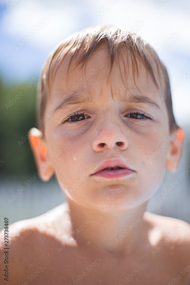 Boy with questioned expression is dripping wet from summer pool. Boy with questioned expression is dripping wet from summer pool.