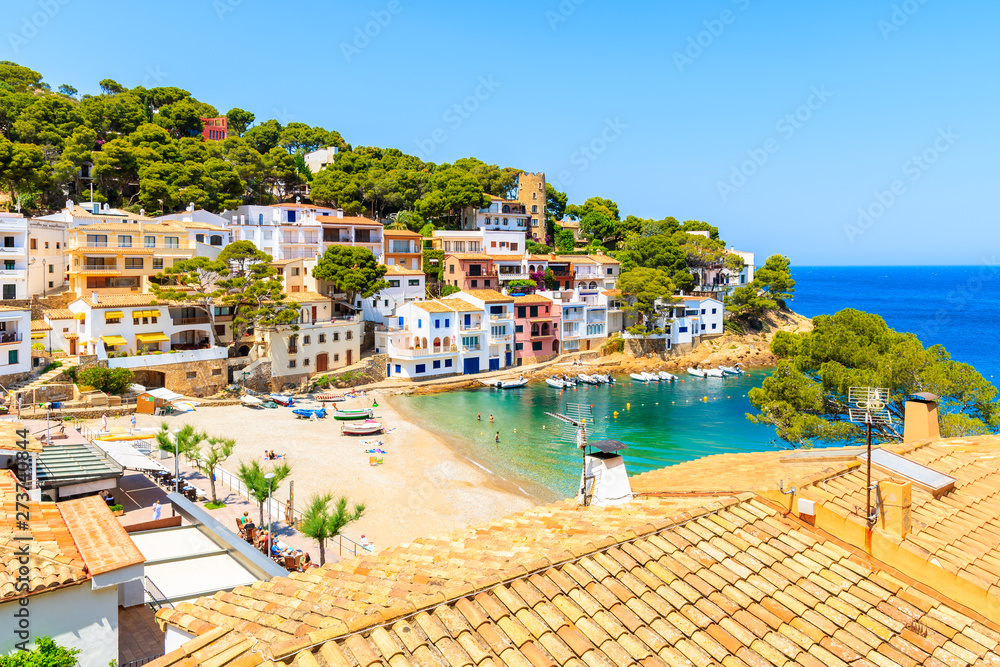 View of colorful houses in sea bay with beach in Sa Tuna coastal village, Costa Brava, Spain