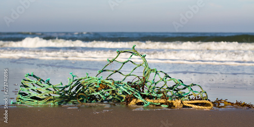 Photography Abandoned fishing net at the beach; ocean pollution