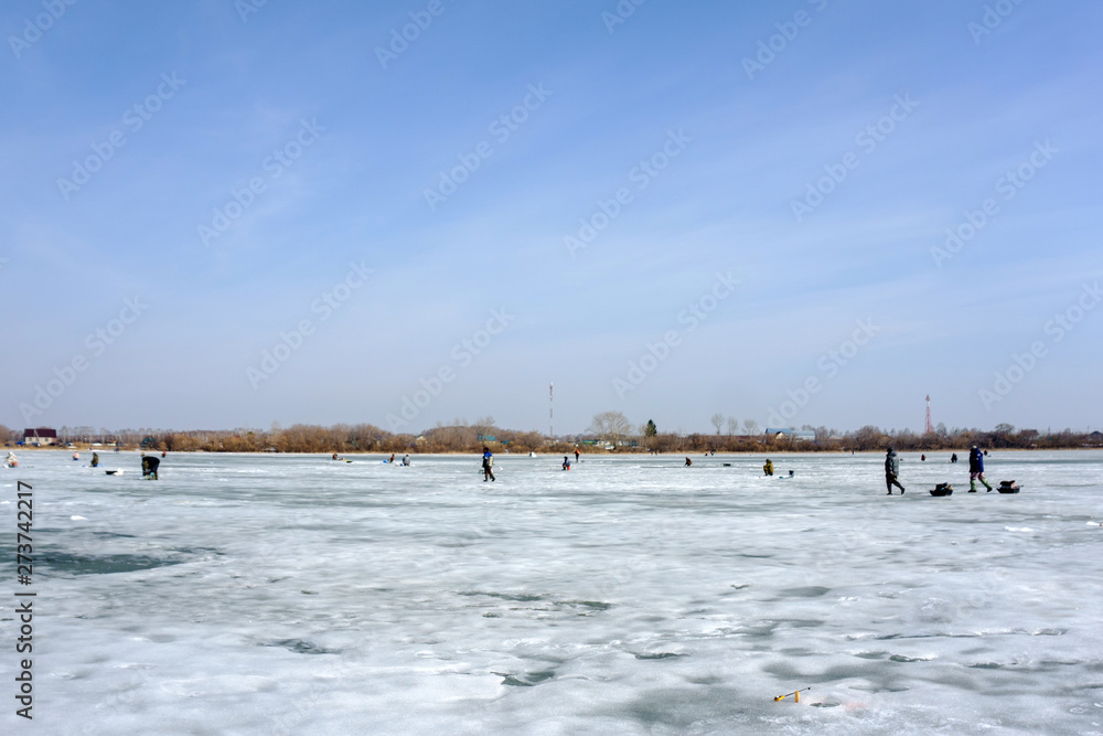 the fisherman on winter fishing on a winter lake