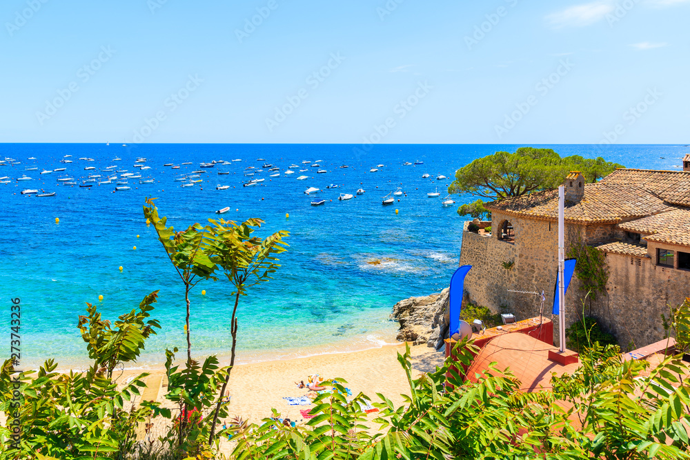 Fototapeta premium Amazing beach in Calella de Palafrugell, scenic fishing village with white houses and sandy beach with clear blue water, Costa Brava, Catalonia, Spain