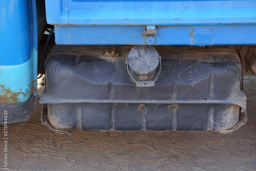 one big gray iron gasoline tank on a blue truck one big gray iron gasoline tank on a blue truck