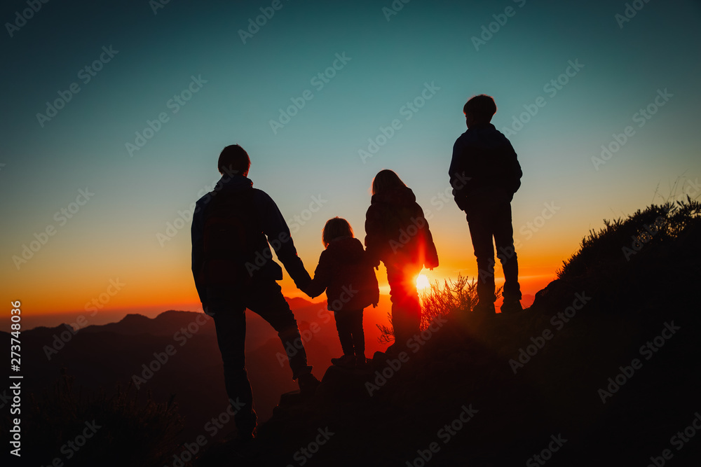 happy father with kids travel in sunset mountains