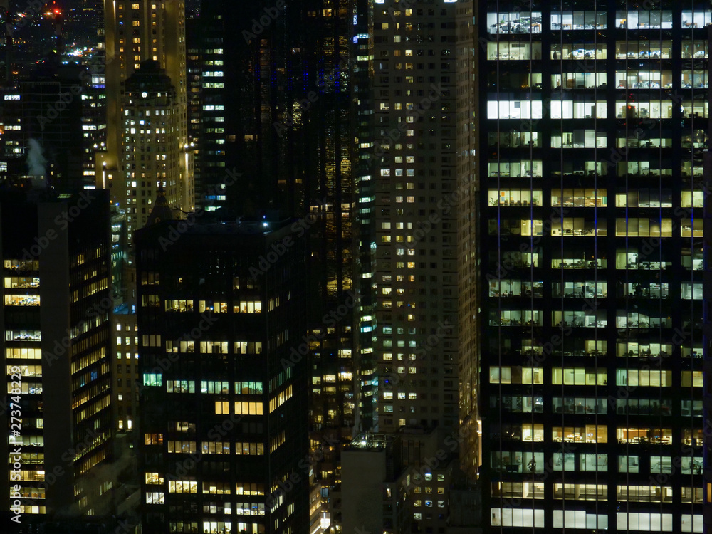 Workers in corporate offices stay up late to extend their already long workday. Workers in corporate offices stay up late to extend their already long workday.