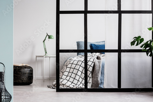 Scandinavian bedroom interior with comfortable bed and mullions wall photo