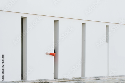 Exterior view of white building with red arm