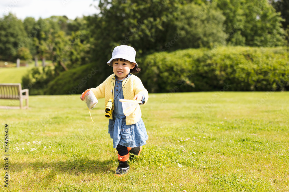 toddler girl playing exploration in spring park toddler girl playing exploration in spring park