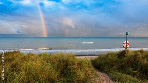 Fototapeta Naklejka Na Ścianę i Meble -  rainbow over water at coast of the baltic sea