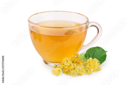 Tea from Linden flowers in glass cup with flower clusters of lime isolated on white background