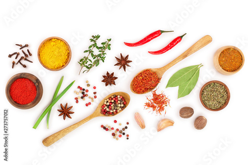 mix of spices in wooden spoon isolated on a white background with copy space for your text. Top view. Flat lay. Set or collection